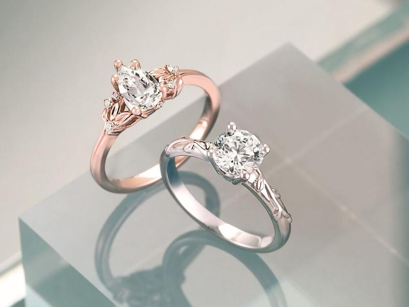 Pear and round diamond solitaire engagement rings in rose and white gold