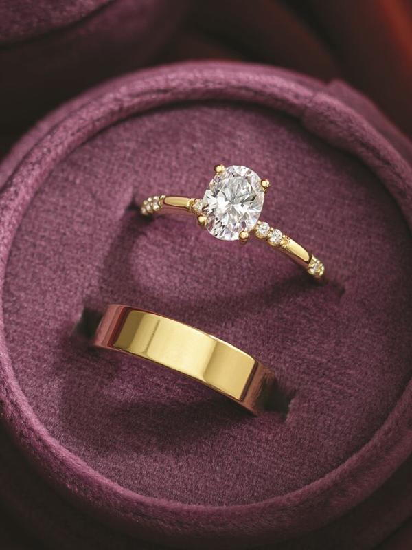 Oval pavé diamond engagement ring with flat gold wedding band