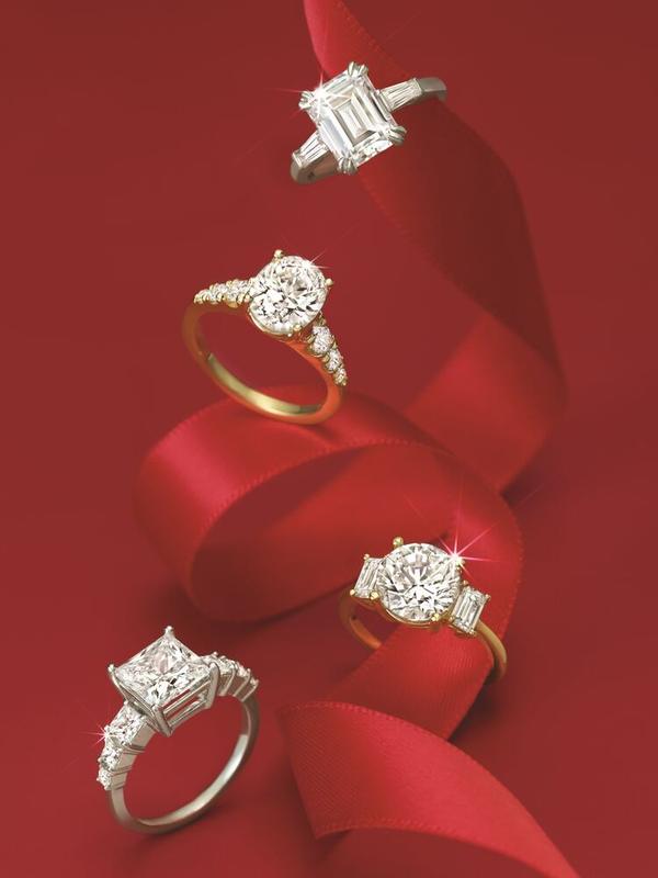 Emerald-cut, halo, and princess-cut diamond rings on red velvet