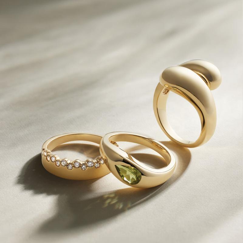 Sculpted gold dome rings with a bezel-set peridot