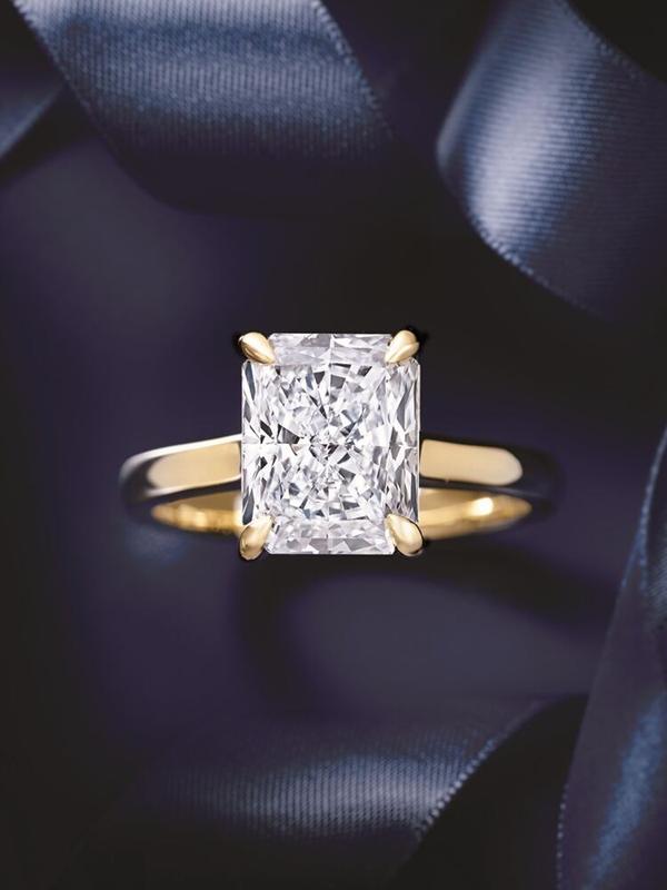 Radiant-cut diamond solitaire engagement ring in yellow gold