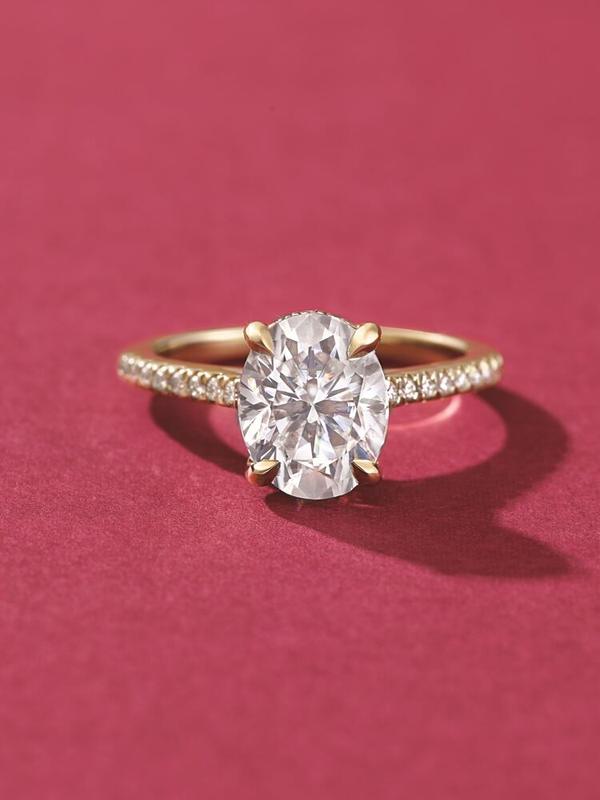 Oval pavé cathedral diamond engagement ring in yellow gold