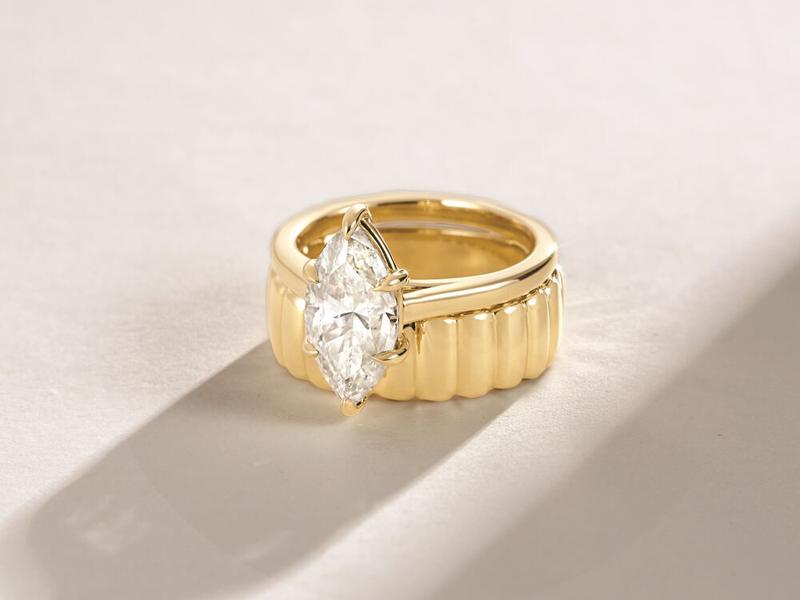 Marquise diamond ring on a fluted cigar band — custom wedding rings
