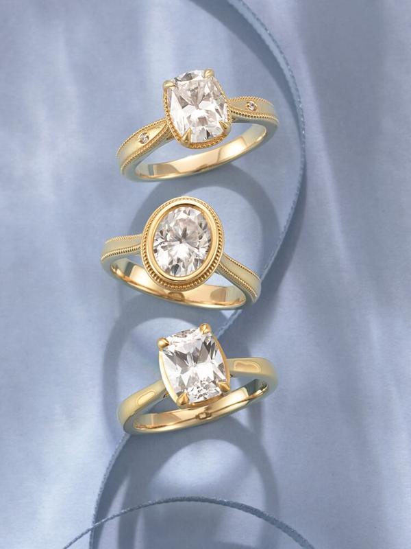 Milgrain and bezel-set oval diamond rings in gold