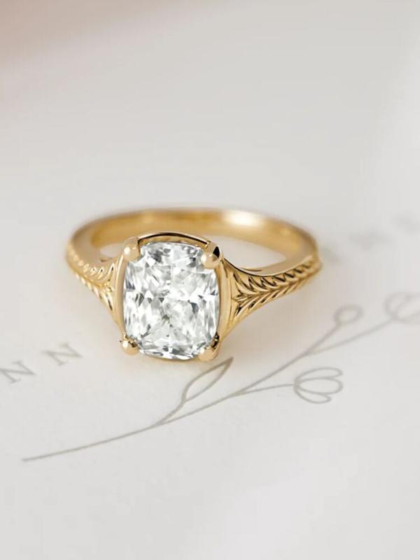 Cushion-cut diamond engagement ring with engraved shank