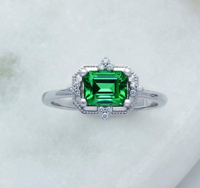 Emerald and diamond milgrain halo ring in white gold