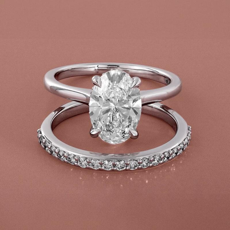 Oval diamond ring on a reverse split stacking band