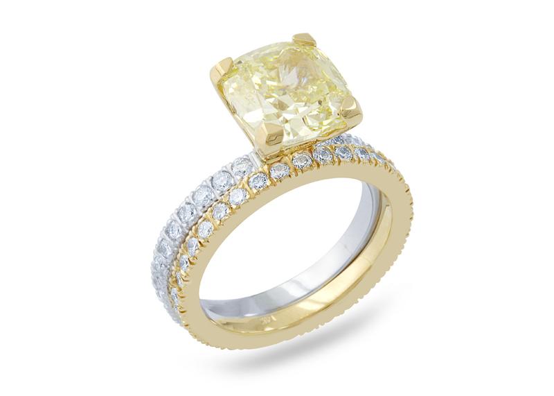 Fancy yellow cushion-cut diamond ring on a two-tone pavé band