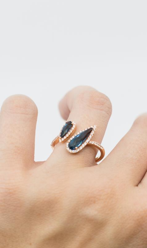 Black gemstone wrap ring in rose gold worn on hand