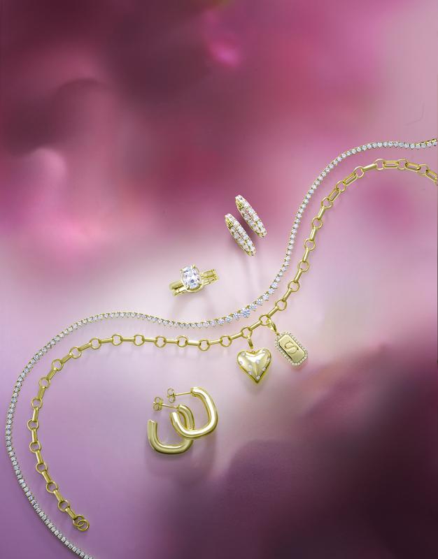 Gold necklaces, hoop earrings and diamond ring flat lay