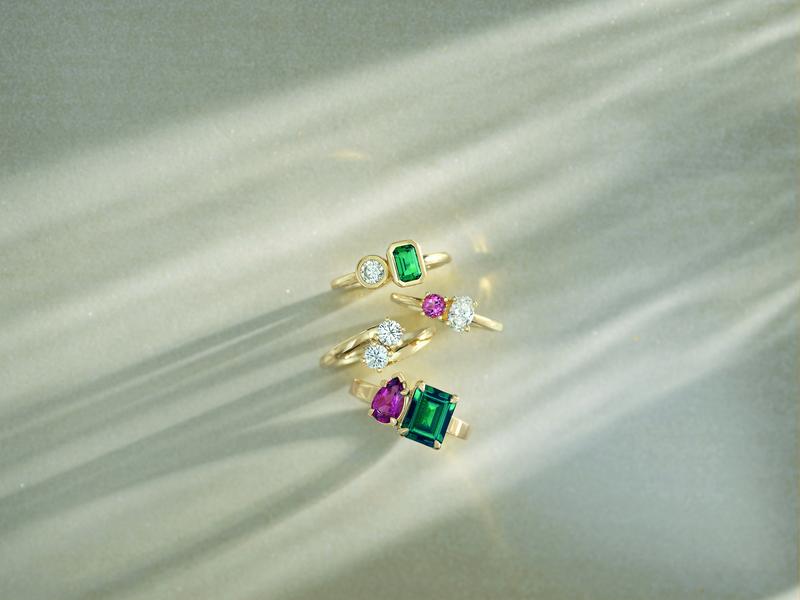 Three gemstone rings in yellow gold — emerald, diamond, pink