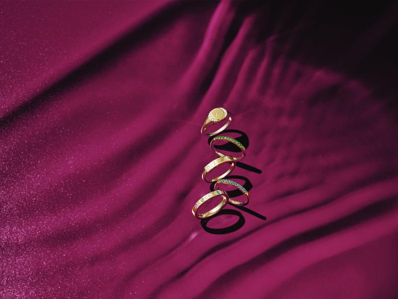 Gold signet rings on crimson silk