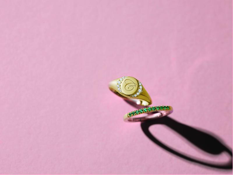 Engraved gold signet ring and emerald pavé band