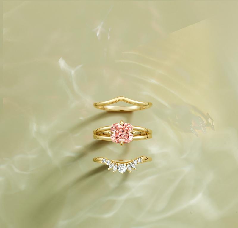 Gold bridal ring stack with peach cushion-cut center