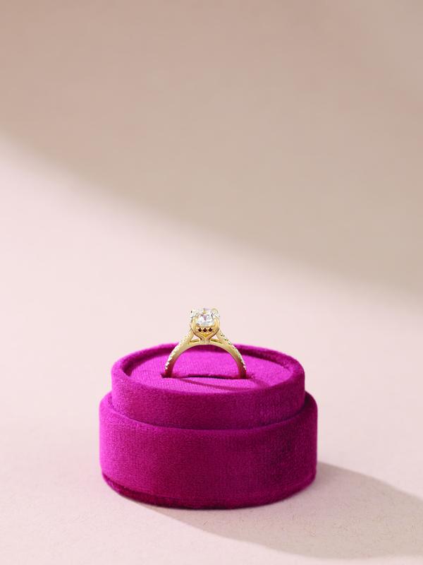 Gold diamond solitaire in magenta velvet ring box