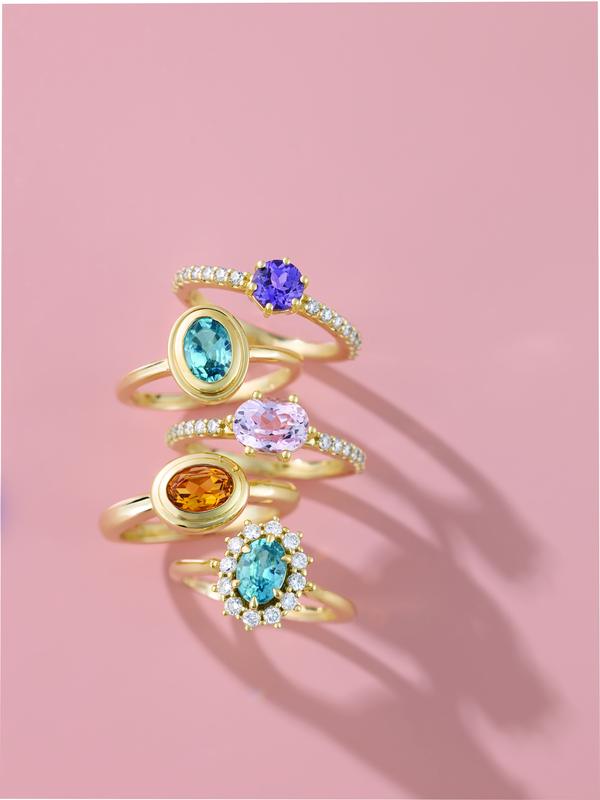 Bezel-set gemstone stacking rings in yellow gold