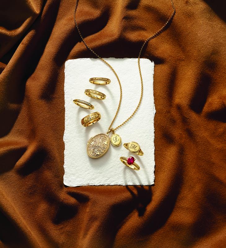Gold locket and rings styled on silk