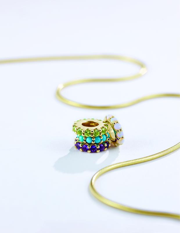 Gemstone spacer charms on a gold snake chain