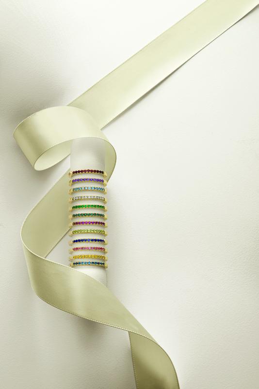 Gemstone eternity bands on ribbon spool