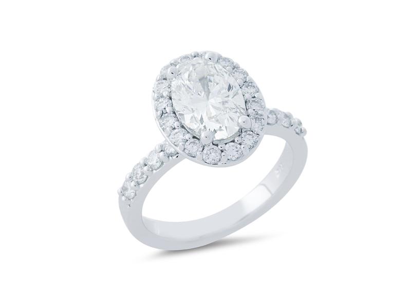 Custom oval diamond halo engagement ring in white gold