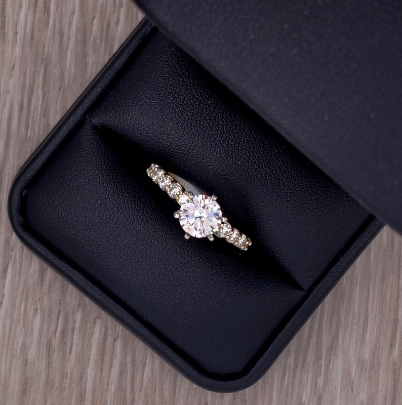 Custom three-stone diamond engagement ring in a leather ring box