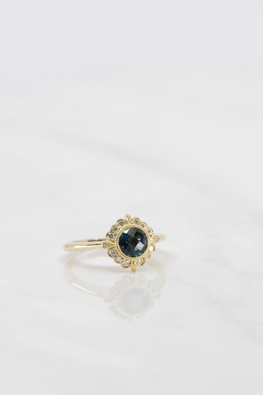 Custom blue sapphire halo ring in yellow gold